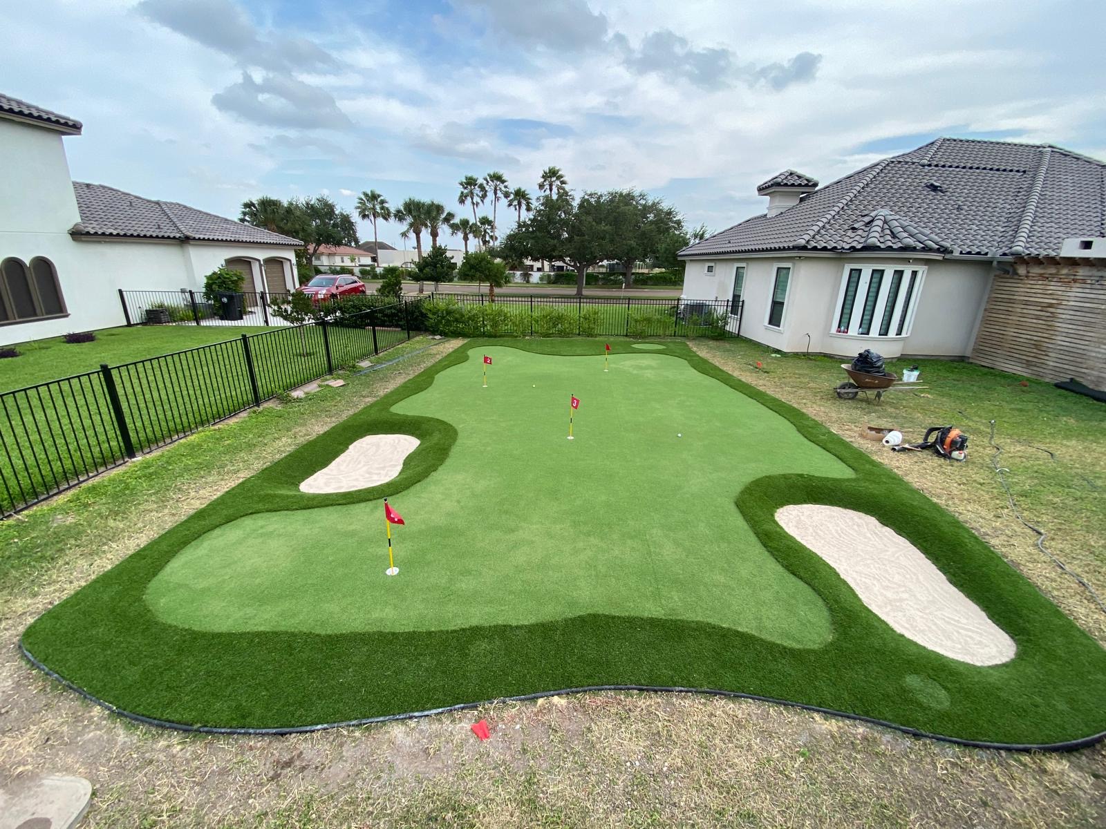 Custom turf putting green with sand bunkers